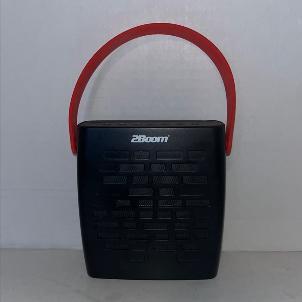 Black and Red Portable Speaker with Textured Design.
Previously used